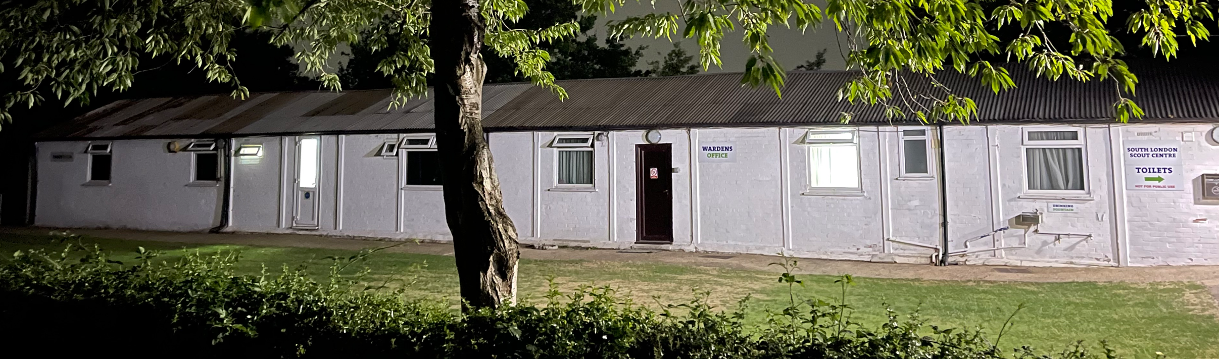 The Troop Room building at night 